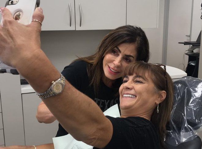 Dental patient taking selfie with Doctor Alani