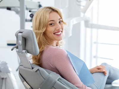 Woman smiling while sitting in treatment chair