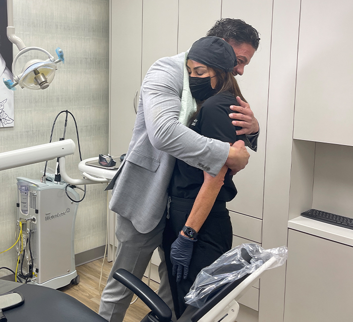 Man hugging Doctor Alani after receiving dental services in Houston from her