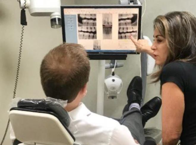 Doctor Alani showing a patient their digital dental x rays on computer monitor