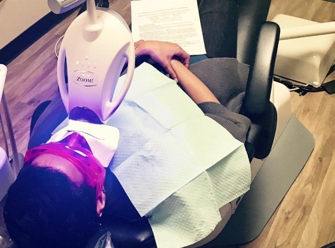 Dental patient getting professional teeth whitening in dental office