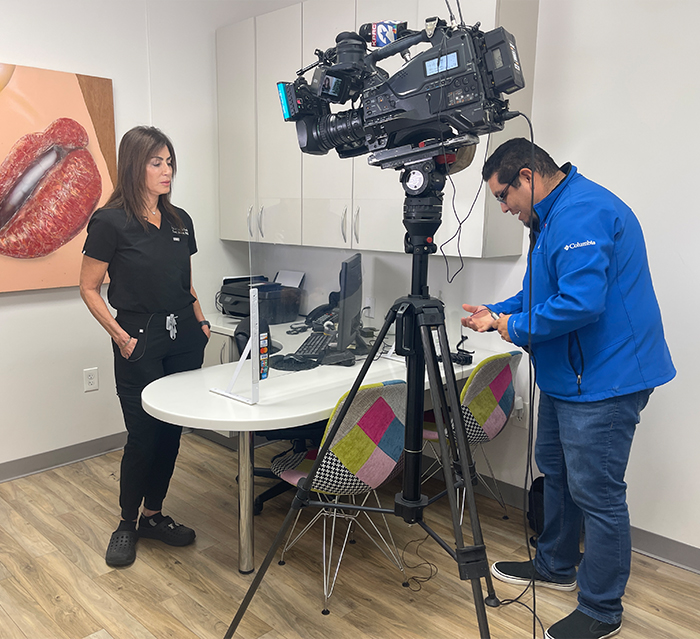 Doctor Alani talking to man behind new television camera