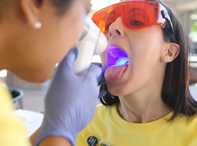 Dentist giving a patient an oral cancer screening