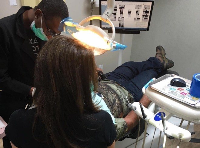 Doctor Alani and dental assistant giving a patient a smile makeover