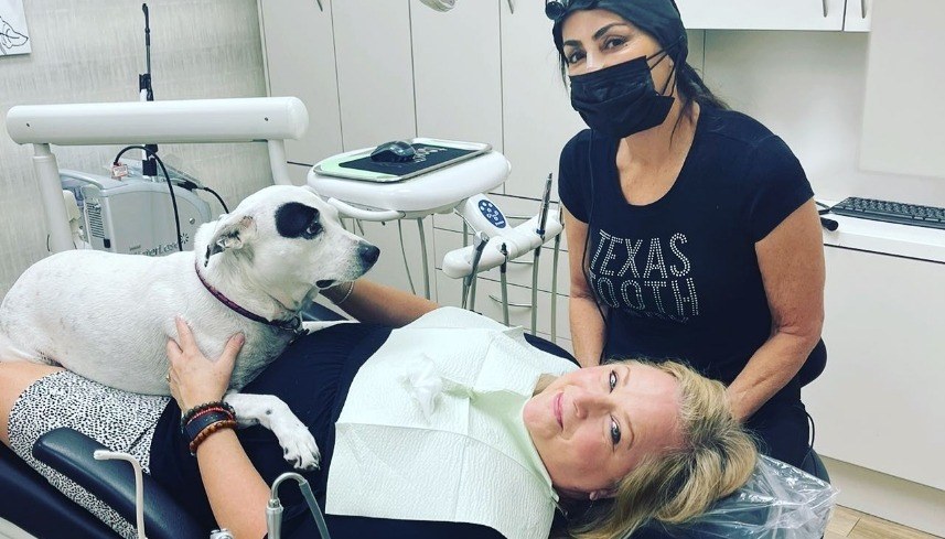 Doctor Alani and dental patient with Piper smiling at camera