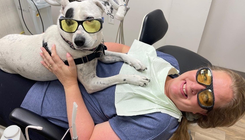 Dental patient and Piper both wearing yellow tinted sunglasses