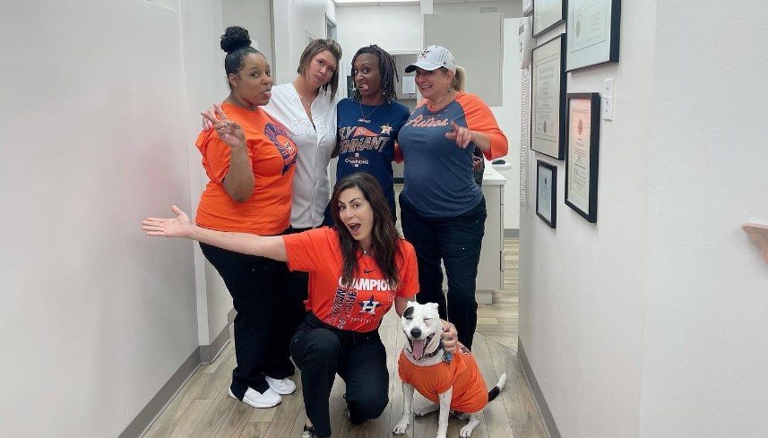 Terri Alani D D S team and Piper wearing Houston Astros shirts