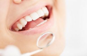 A person smiling at their dental exam.