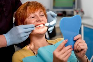 A woman viewing her straighter smile.