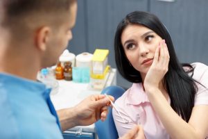 A concerned patient looking at her dentist.