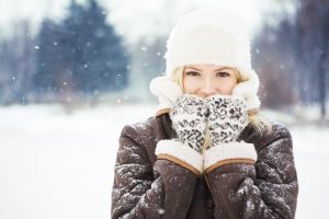 A woman standing outside in the cold.