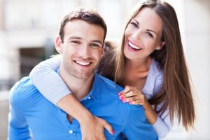 A young couple smiling.