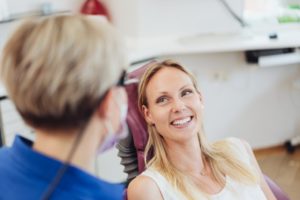 Dentist explaining how to maximize dental insurance benefits to patient.