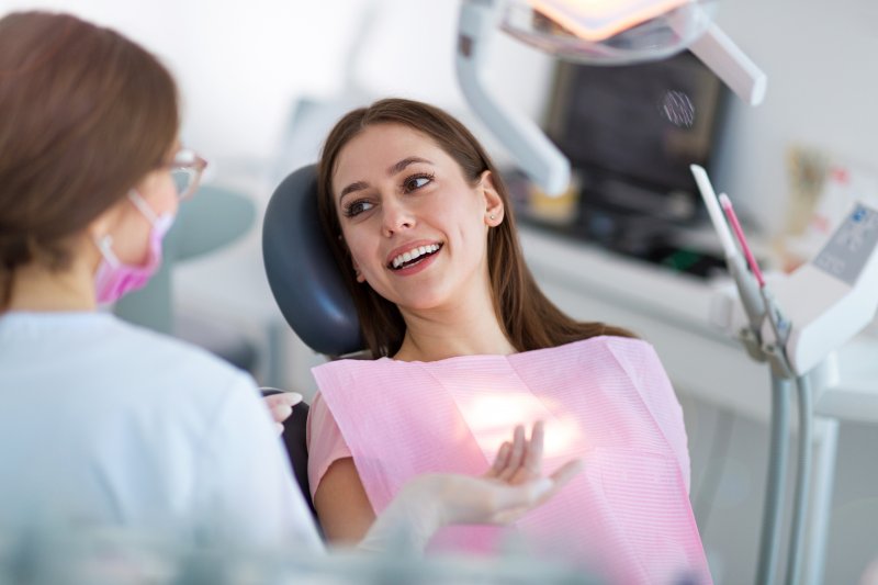 Dentist discussing the difference between veneers and bonding with a patient