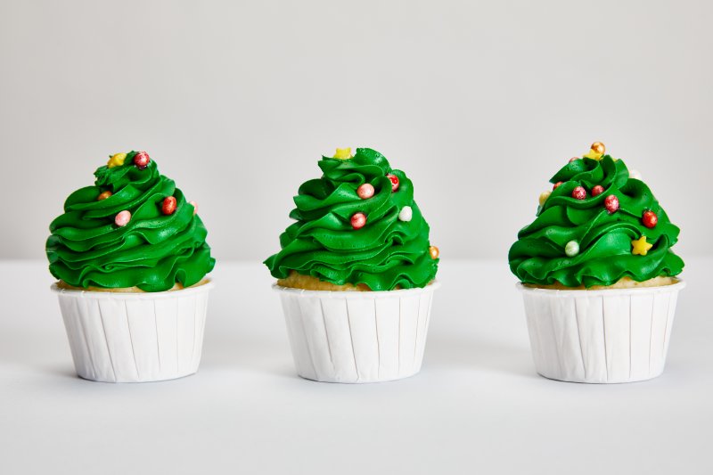 Row of green cupcakes that can harm oral health