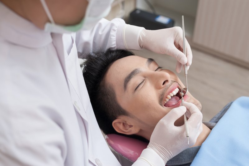 Man receiving dental checkup for his new year’s resolution