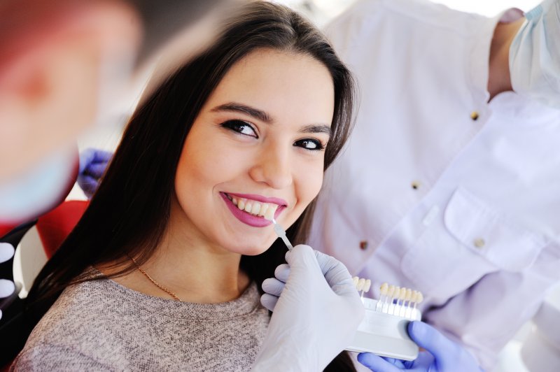 Woman learning about the veneers process in Uptown Houston