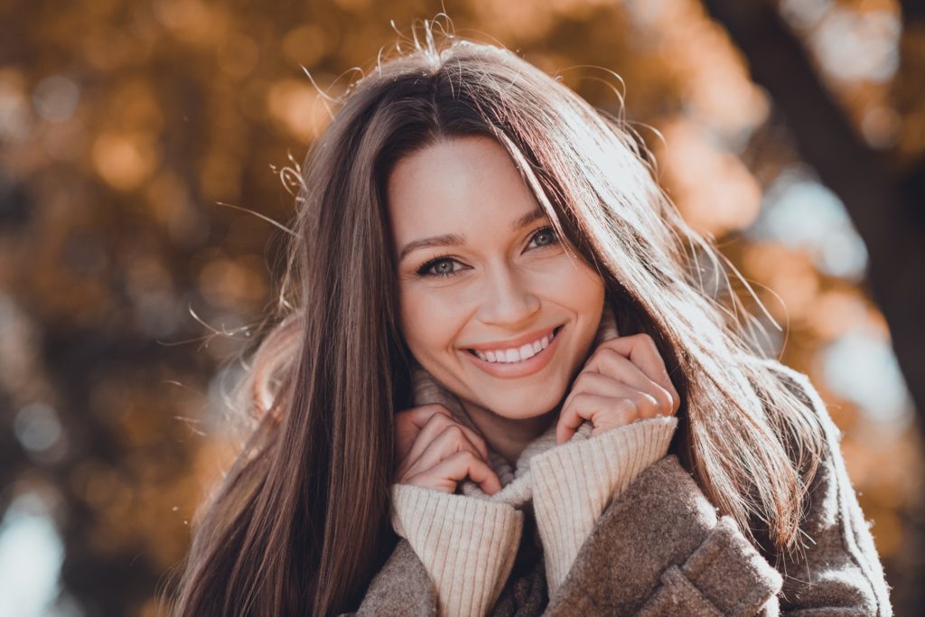 Woman smiling while walking outside