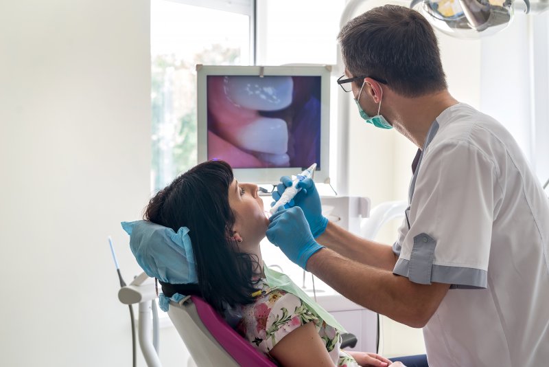 A dentist helping his patient with early-year checkups