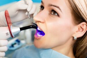 Woman with brown eyes undergoing dental bonding procedure