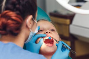 Young patient getting worked on at dentist.